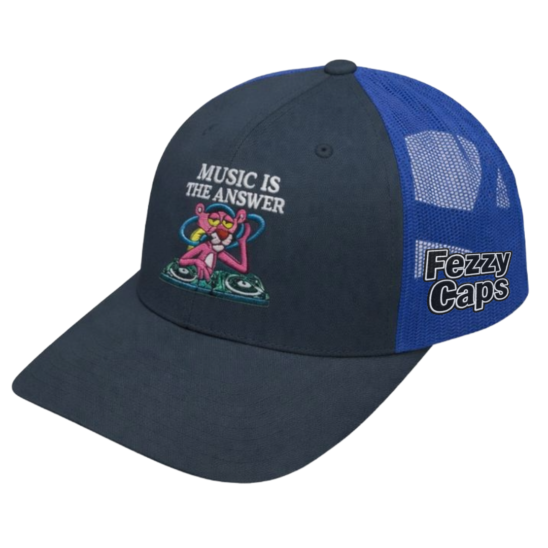 Blue and black cap with 'Music is the Answer' text and pink character design on a white background